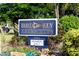 Elegant Bird Key Yacht Club sign surrounded by flowers and greenery, offering exclusivity to members at 355 W Royal Flamingo Dr, Sarasota, FL 34236