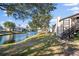 Waterfront backyard featuring lush grass, mature trees, and a picturesque view of the serene canal at 3863 59Th W Ave # 4189, Bradenton, FL 34210