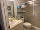 A functional bathroom features a combined shower and bathtub, with a sleek sliding door and ample storage at 3863 59Th W Ave # 4189, Bradenton, FL 34210