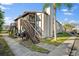 Condo exterior with wood stairs, a sidewalk, and a glimpse of a palm tree in a well maintained landscape at 3863 59Th W Ave # 4189, Bradenton, FL 34210