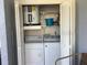 Functional laundry closet with washer, dryer, and storage shelves for convenient laundry needs at 3863 59Th W Ave # 4189, Bradenton, FL 34210