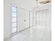 An entryway with white tile flooring, chandelier, and a coat closet at 4119 Royal Palm Dr, Bradenton, FL 34210