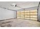 A spacious garage featuring a garage door with horizontal bars and a concrete floor at 4119 Royal Palm Dr, Bradenton, FL 34210