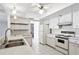 Well-lit kitchen with a double sink, white appliances, and ample counter space at 4119 Royal Palm Dr, Bradenton, FL 34210