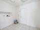 This laundry room features tile floors, an outlet for a dryer, and a small step stool at 4119 Royal Palm Dr, Bradenton, FL 34210