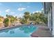 Outdoor pool with calm, clear water and a view of the canal and landscaping at 4119 Royal Palm Dr, Bradenton, FL 34210