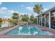 Outdoor pool with calm, clear water next to a screened in porch at 4119 Royal Palm Dr, Bradenton, FL 34210