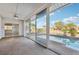 This sunroom offers views of the pool and canal from the wall-to-wall sliding glass doors at 4119 Royal Palm Dr, Bradenton, FL 34210