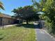 Grassy backyard featuring a sidewalk adjacent to a chain link fence at 4197 66Th Street W Cir, Bradenton, FL 34209