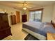 Bedroom with neutral tones, tiled floor, and a private door to a screened patio at 4197 66Th Street W Cir, Bradenton, FL 34209