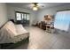 Bright bedroom with a ceiling fan, tiled floors, and sliding glass doors to the patio at 4197 66Th Street W Cir, Bradenton, FL 34209