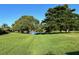 Expansive green space with mature trees and a pond, offering a serene environment at 4197 66Th Street W Cir, Bradenton, FL 34209