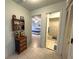 Hallway leading to the bedroom and bathroom, complemented by tiled floors and classic decor at 4197 66Th Street W Cir, Bradenton, FL 34209