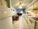 Kitchen featuring white cabinetry, tiled floors, and a view into the living area at 4197 66Th Street W Cir, Bradenton, FL 34209