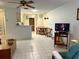 Living room features tile flooring that flows into the dining area and open kitchen space at 4197 66Th Street W Cir, Bradenton, FL 34209