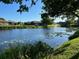 Picturesque pond with a fountain surrounded by lush green grass and lily pads at 4197 66Th Street W Cir, Bradenton, FL 34209