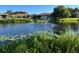 Scenic view of a pond with a fountain and lush greenery, adding to the community's charm at 4197 66Th Street W Cir, Bradenton, FL 34209