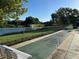 Outdoor shuffleboard courts overlooking a serene lake at 4197 66Th Street W Cir, Bradenton, FL 34209