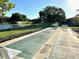 Outdoor shuffleboard courts overlooking a serene lake at 4197 66Th Street W Cir, Bradenton, FL 34209