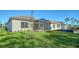 A screened lanai is visible from the grassy backyard of this single-Gathering home at 421 Potenza Loop, Nokomis, FL 34275