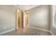 Bedroom featuring tile floors, white base trim, and views into the walk-in closet and hallway at 421 Potenza Loop, Nokomis, FL 34275