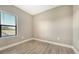 Bright bedroom with tile flooring, base trim and a window offering a pleasant outdoor view at 421 Potenza Loop, Nokomis, FL 34275