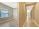 Inviting hallway with elegant wood-look flooring, offering a glimpse into the adjacent bedroom with a bright window at 421 Potenza Loop, Nokomis, FL 34275