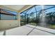 Screened lanai providing an outdoor space with peaceful view of the backyard and trees at 421 Potenza Loop, Nokomis, FL 34275