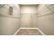 Spacious walk-in closet with ample shelving and stylish wood-look tile flooring at 421 Potenza Loop, Nokomis, FL 34275