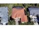 Gorgeous aerial view showing tile roof, mature trees, landscaping, screened pool and patio, and private yard at 4245 Corso Venetia Blvd, Venice, FL 34293