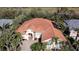 Stunning aerial view of the home, showing the tile roof, the surrounding mature trees, and lush landscaping at 4245 Corso Venetia Blvd, Venice, FL 34293