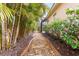 Picturesque backyard pathway lined with lush greenery and decorative stones at 4245 Corso Venetia Blvd, Venice, FL 34293