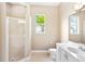 Bright bathroom featuring a glass shower and double sinks at 4245 Corso Venetia Blvd, Venice, FL 34293