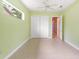 Spacious bedroom featuring tile floors, a ceiling fan, and a double door closet at 4245 Corso Venetia Blvd, Venice, FL 34293