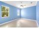 Bright bedroom featuring light blue walls, tile floors and a large window offering exterior views at 4245 Corso Venetia Blvd, Venice, FL 34293