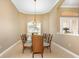 Formal dining room showcasing a chandelier and a glass-top table with seating for six at 4245 Corso Venetia Blvd, Venice, FL 34293