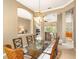 Elegant dining room featuring a glass-top table, stylish seating, and a decorative chandelier at 4245 Corso Venetia Blvd, Venice, FL 34293