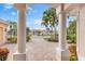 Elegant home exterior with a brick driveway, well-manicured landscaping, and a charming entryway at 4245 Corso Venetia Blvd, Venice, FL 34293