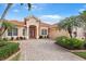 Charming home exterior boasting a brick driveway, meticulous landscaping, and a welcoming entrance at 4245 Corso Venetia Blvd, Venice, FL 34293
