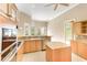 Bright kitchen with wood cabinets, granite countertops, and a view to the outdoors at 4245 Corso Venetia Blvd, Venice, FL 34293