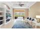 Bright living room featuring an entertainment center, tile flooring, and sliding doors to the pool at 4245 Corso Venetia Blvd, Venice, FL 34293