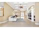 Spacious living room featuring a large entertainment center, coffered ceilings, and tile flooring at 4245 Corso Venetia Blvd, Venice, FL 34293