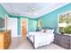 Main bedroom with tray ceilings, neutral paint and a doorway leading to the main bathroom at 4245 Corso Venetia Blvd, Venice, FL 34293