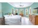 Main bedroom featuring tile floors, tray ceilings and several large windows allowing in natural light at 4245 Corso Venetia Blvd, Venice, FL 34293