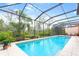 Enjoy a stunning backyard pool surrounded by lush greenery and a screened enclosure at 4245 Corso Venetia Blvd, Venice, FL 34293