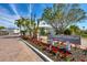 Welcoming entrance to Longboat Harbour community featuring lush landscaping, colorful flowers, and clear signage at 4310 Falmouth Dr # 102, Longboat Key, FL 34228