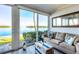 Bright living room with a comfortable sofa, stylish decor, and water views at 4310 Falmouth Dr # 102, Longboat Key, FL 34228