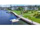 Scenic waterfront condo with a canal, dock, and lush landscaping, offering serene waterfront living at 4310 Falmouth Dr # 102, Longboat Key, FL 34228