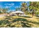 Spacious backyard featuring mature trees and a well-maintained lawn, ideal for relaxation and entertainment at 4540 Maverick St, North Port, FL 34288