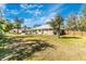 A spacious backyard that is partially fenced with lush greenery providing an open and airy feel to the property at 4540 Maverick St, North Port, FL 34288